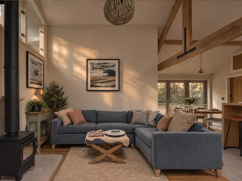 The blue sofa and armchair in the warmly lit living room