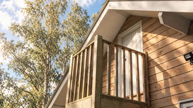 Timber balcony and exterior cladding beneath the workshop roof