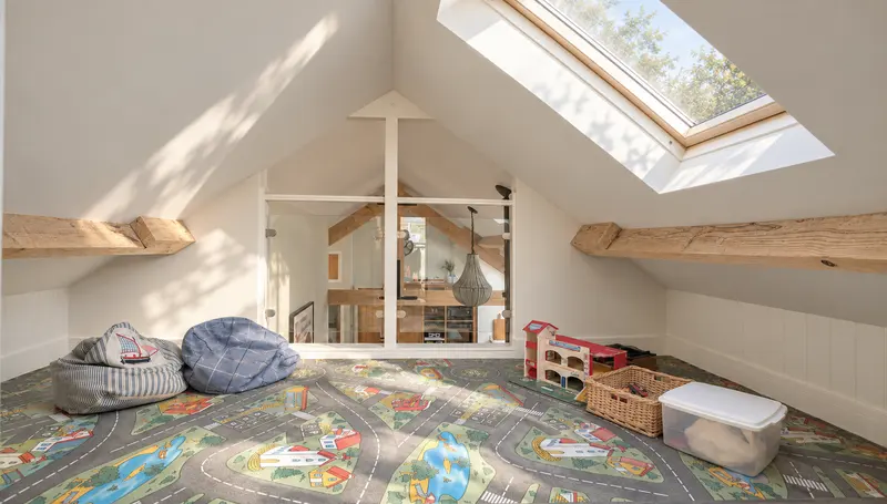 The upstairs family playroom with its road-pattern floor and toys