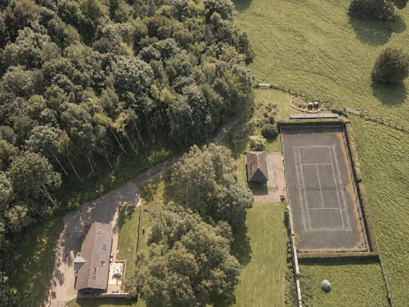 Aerial view of the woodland grounds and tennis court